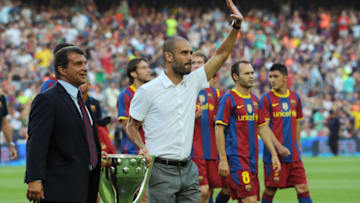 Former Barcelona president Joan Laparta (L) holds the 2009-2010 La Liga trophy with Barcelona manager Josep Guardiola. (Photo by Denis Doyle/Getty Images)