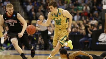 Mar 19, 2015; Pittsburgh, PA, USA; Notre Dame Fighting Irish guard Steve Vasturia (32) dribbles the ball as Northeastern Huskies guard Zach Stahl (33) chases during the second half in the second round of the 2015 NCAA Tournament at Consol Energy Center. Mandatory Credit: Geoff Burke-USA TODAY Sports