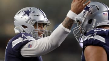 ARLINGTON, TEXAS - DECEMBER 15: Dak Prescott #4 of the Dallas Cowboys celebrates with La'el Collins #71 of the Dallas Cowboys after the Dallas Cowboys scored a touchdown against the Los Angeles Rams in the second quarter at AT&T Stadium on December 15, 2019 in Arlington, Texas. (Photo by Tom Pennington/Getty Images)