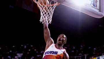 PHOENIX, AZ - 1998: Antonio McDyess #34 of the Phoenix Suns drives to the basket against the Houston Rockets during the 1998 season at the American West Arena in Phoenix, Arizona. NOTE TO USER: User expressly acknowledges and agrees that, by downloading and or using this photograph, User is consenting to the terms and conditions of the Getty Images License Agreement. Mandatory Copyright Notice: Copyright 1998 NBAE (Photo by Barry Gossage/NBAE via Getty Images)