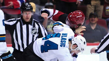 Mar 17, 2016; Glendale, AZ, USA; Arizona Coyotes center Max Domi (16) and San Jose Sharks defenseman Marc-Edouard Vlasic (44) fight during the second period at Gila River Arena. Mandatory Credit: Matt Kartozian-USA TODAY Sports