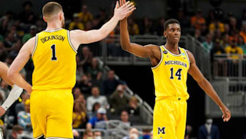 Mar 17, 2022; Indianapolis, IN, USA; Michigan Wolverines center Hunter Dickinson (1) high-fives forward Moussa Diabate (14) during a stop in play against the Colorado State Rams in the second half during the first round of the 2022 NCAA Tournament at Gainbridge Fieldhouse. Mandatory Credit: Robert Goddin-USA TODAY Sports