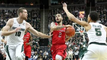 Jan 31, 2016; East Lansing, MI, USA; Rutgers Scarlet Knights guard Bishop Daniels (2) drives to the basket against Michigan State Spartans forward Matt Costello (10) and guard Bryn Forbes (5) during the first half of a game at Jack Breslin Student Events Center. Mandatory Credit: Mike Carter-USA TODAY Sports
