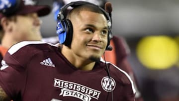 Nov 8, 2014; Starkville, MS, USA; Mississippi State Bulldogs quarterback Dak Prescott (15) smiles while on the headsets after coming out of the game against the UT Martin Skyhawks during the fourth quarter at Davis Wade Stadium. Mandatory Credit: John David Mercer-USA TODAY Sports