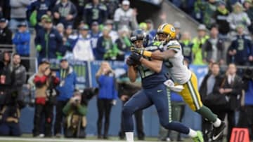 Jan 18, 2015; Seattle, WA, USA; Seattle Seahawks wide receiver Jermaine Kearse (15) catches the game winning touchdown pass of 35 yards defended by Green Bay Packers cornerback Tramon Williams (38) in overtime in the NFC Championship Game at CenturyLink Field. The Seahawks defeated the Packers 28-22 in overtime. Mandatory Credit: Kirby Lee-USA TODAY Sports