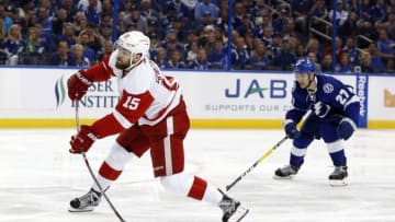 Apr 21, 2016; Tampa, FL, USA; Detroit Red Wings center Riley Sheahan (15) shoots as Tampa Bay Lightning left wing Jonathan Drouin (27) attempts to defend during the second period of game five of the first round of the 2016 Stanley Cup Playoffs at Amalie Arena. Mandatory Credit: Kim Klement-USA TODAY Sports