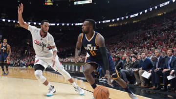 PORTLAND, OR - SEPTEMBER 25: Shelvin Mack #8 of the Utah Jazz drives to the basket on Evan Turner #1 of the Portland Trail Blazers in the third quarter of an NBA game at the Moda Center on September 25, 2016 in Portland, Oregon. The Blazers won 113-104. NOTE TO USER: User expressly acknowledges and agrees that by downloading and/or using this photograph, user is consenting to the terms and conditions of the Getty Images License Agreement. (Photo by Steve Dykes/Getty Images)