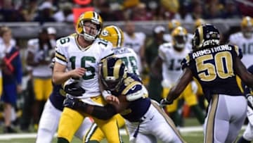 Aug 16, 2014; St. Louis, MO, USA; Green Bay Packers quarterback Scott Tolzien (16) gets a pass away before getting hit by St. Louis Rams defensive end Michael Sam (96) during the second half at Edward Jones Dome. Mandatory Credit: Scott Rovak-USA TODAY Sports