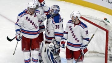 May 19, 2014; Montreal, Quebec, CAN; New York Rangers goalie Henrik Lundqvist (30) celebrates the win over the Montreal Canadiens with teammates Kevin Klein (8) and Marc Staal (18) and Derek Stepan (21) in game two of the Eastern Conference Final of the 2014 Stanley Cup Playoffs at the Bell Centre. Mandatory Credit: Eric Bolte-USA TODAY Sports