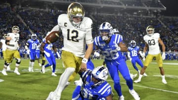 DURHAM, NORTH CAROLINA - NOVEMBER 09: Josh Blackwell #31 and Michael Carter II #26 of the Duke Blue Devils chase Ian Book #12 of the Notre Dame Fighting Irish out of bounds during the first quarter of their game at Wallace Wade Stadium on November 09, 2019 in Durham, North Carolina. (Photo by Grant Halverson/Getty Images)