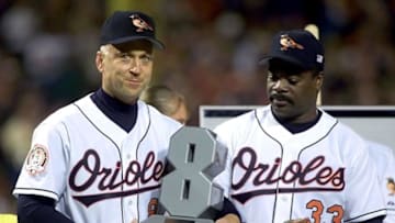 BALTIMORE, UNITED STATES: Baseball "Iron Man" Cal Ripken (L) holds a model of his newly retired number as he is joined by former Orioles teammate Eddie Murry during a farewell ceremony for the retiring Baltimore Oriole 06 October, 2001, at Camden Yards in Baltimore, Maryland. Tonight is Ripken's 3,001 game as a major league Baselball player. Ripken also holds the record for most consecutive games played, 2,632. AFP PHOTO / STEPHEN JAFFE (Photo credit should read STEPHEN JAFFE/AFP via Getty Images)