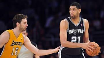March 19, 2014; Los Angeles, CA, USA; San Antonio Spurs forward Tim Duncan (21) controls the ball against Los Angeles Lakers center Pau Gasol (16) during the first half at Staples Center. Mandatory Credit: Gary A. Vasquez-USA TODAY Sports