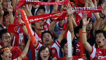 HANOI, VIETNAM - JULY 17: Vietnamese Arsenal fans show their support during the international friendly match between Vietnam and Arsenal FC at My Dinh National Stadium on July 17, 2013 in Hanoi, Vietnam. (Photo by Chris McGrath/Getty Images)
