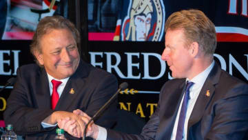 Dec 4, 2014; Ottawa, Ontario, Canada; Ottawa Senators owner Eugene Melnyk shakes hands with Daniel Alfredsson before Alfredsson announces that he will retiring from hockey during a press conference at Canadian Tire Centre. Mandatory Credit: Marc DesRosiers-USA TODAY Sports