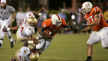 MIAMI - September 10: University of Miami Hurricane Frank Gore #3 is brought down by Florida State Seminoles A.J. Nicholson #54 and Ray Piquion #56. The Hurricanes won in overtime 16-10 on September 10, 2004 at the Orange Bowl Stadium in Miami, Florida. (Photo by Robert Laberge/Getty Images)