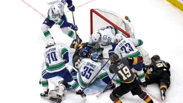 The Vancouver Canucks and Vegas Golden Knights battle for the puck as Thatcher Demko #35 tends net during the first period in Game Five of the Western Conference Second Round. (Photo by Bruce Bennett/Getty Images)