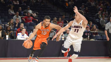 LYNCHBURG, VA - NOVEMBER 17: Ria'n Holland #10 of the Mercer Bears dribbles around Georgie Pacheco-Ortiz #11 of the Liberty Flames during quarterfinal of the Paradise Jam college basketball tournament at The Vines Center on November 17, 2017 in Lynchburg, Virginia. (Photo by Mitchell Layton/Getty Images)