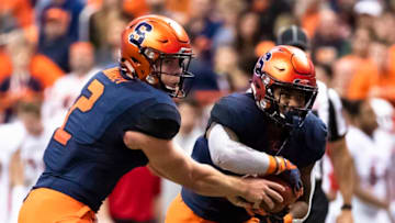 SYRACUSE, NY - NOVEMBER 09: Eric Dungey #2 hands the ball off to Moe Neal #21 of the Syracuse Orange during the second quarter against the Louisville Cardinals at the Carrier Dome on November 9, 2018 in Syracuse, New York. (Photo by Brett Carlsen/Getty Images)