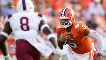 Sep 11, 2021; Clemson, South Carolina, USA; Clemson Tigers quarterback D.J. Uiagalelei (5) carries the ball against South Carolina State Bulldogs safety Jalen Barr (8) during the third quarter at Memorial Stadium. Mandatory Credit: Adam Hagy-USA TODAY Sports