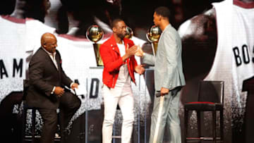 Former Miami Heat player Dwyane Wade greets former Miami Heat player Chris Bosh during the Miami Heat Dwyane Wade L3GACY Celebration (Photo by Michael Reaves/Getty Images)