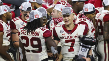 Dec 19, 2020; Arlington, Texas, USA; Oklahoma Sooners quarterback Spencer Rattler (7) laughs with running back Rhamondre Stevenson (29) after the game against the Iowa State Cyclones at AT&T Stadium. Mandatory Credit: Kevin Jairaj-USA TODAY Sports