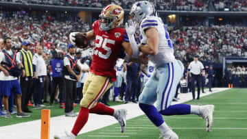 ARLINGTON, TEXAS - JANUARY 16: Elijah Mitchell #25 of the San Francisco 49ers rushes for a touchdown past Leighton Vander Esch #55 of the Dallas Cowboys during the first quarter in the NFC Wild Card Playoff game at AT&T Stadium on January 16, 2022 in Arlington, Texas. (Photo by Tom Pennington/Getty Images)