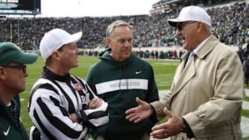 EAST LANSING, MI - OCTOBER 20: Head coach Mark Dantonio of the Michigan State Spartans talks with officials about the current weather delay while playing the Michigan Wolverines at Spartan Stadium on October 20, 2018 in East Lansing, Michigan. (Photo by Gregory Shamus/Getty Images)