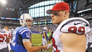 Dec 14, 2014; Indianapolis, IN, USA; Indianapolis Colts quarterback Andrew Luck (12) shakes hands with Houston Texans defensive end J.J. Watt (99) after their game at Lucas Oil Stadium. The Indianapolis Colts won, 17-10 to clinch the AFC South Division. Mandatory Credit: Thomas J. Russo-USA TODAY Sports