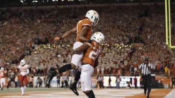 AUSTIN, TX - NOVEMBER 17: John Burt #1 of the Texas Longhorns celebrates with Keaontay Ingram #26 after a second quarter touchdown against the Iowa State Cyclones at Darrell K Royal-Texas Memorial Stadium on November 17, 2018 in Austin, Texas. (Photo by Tim Warner/Getty Images)