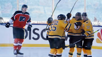 Feb 21, 2021; Stateline, Nevada, USA; Boston Bruins right wing David Pastrnak (88) celebrates with defenseman Jeremy Lauzon (55) and center Patrice Bergeron (37) after scoring a goal against the Philadelphia Flyers during the first period in a NHL Outdoors hockey game at Lake Tahoe. Mandatory Credit: Kirby Lee-USA TODAY Sports