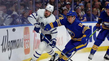 Feb 21, 2023; Buffalo, New York, USA; Buffalo Sabres defenseman Henri Jokiharju (10) defends as Toronto Maple Leafs center Auston Matthews (34) shoots the puck along the boards during the first period at KeyBank Center. Mandatory Credit: Timothy T. Ludwig-USA TODAY Sports