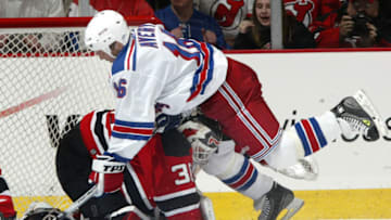 Martin Brodeur is run into by Sean Avery (Photo by Andy Marlin/Getty Images)