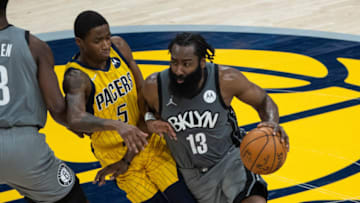 Mar 17, 2021; Indianapolis, Indiana, USA; Brooklyn Nets guard James Harden (13) dribbles the ball while Indiana Pacers guard Edmond Sumner (5) defends in the fourth quarter at Bankers Life Fieldhouse. Mandatory Credit: Trevor Ruszkowski-USA TODAY Sports