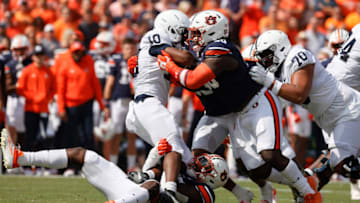 Auburn footballSep 17, 2022; Auburn, Alabama, USA; Penn State Nittany Lions running back Nicholas Singleton (10) is tackled by Auburn Tigers linebacker Derick Hall (29) and defensive lineman Marcus Harris (50) during the first quarter at Jordan-Hare Stadium. Mandatory Credit: John Reed-USA TODAY Sports