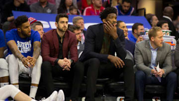PHILADELPHIA, PA - FEBRUARY 23: Jonah Bolden #43, Furkan Korkmaz #30, and Joel Embiid #21 of the Philadelphia 76ers watch the game from the bench against the Portland Trail Blazers in the third quarter at the Wells Fargo Center on February 23, 2019 in Philadelphia, Pennsylvania. The Trail Blazers defeated the 76ers 130-115. NOTE TO USER: User expressly acknowledges and agrees that, by downloading and or using this photograph, User is consenting to the terms and conditions of the Getty Images License Agreement. (Photo by Mitchell Leff/Getty Images)