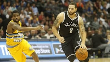 Feb 27, 2014; Denver, CO, USA; Brooklyn Nets guard Deron Williams (8) drives to the basket past Denver Nuggets guard Aaron Brooks (0) during the second half at Pepsi Center. The Nets won 112-89. Mandatory Credit: Chris Humphreys-USA TODAY Sports
