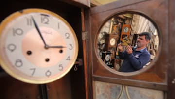 TOPSHOT - Iraqi Hussein Mahmud, 45, works on repairing old and antique clocks at his warehouse in Baghdad's Maidan area on February 20, 2018.Mahmud started this job 30 years ago and says he was taught by his father. He collects clocks from auctions and street sellers, some of these date from 60 to 150 years, and especially German and American ones, after repairing, he sells these clocks to antique fans. / AFP PHOTO / AHMAD AL-RUBAYE (Photo credit should read AHMAD AL-RUBAYE/AFP/Getty Images)