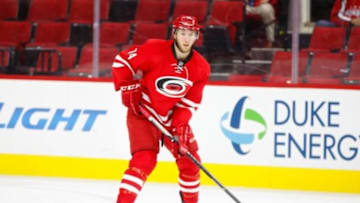 Sep 30, 2015; Raleigh, NC, USA; Carolina Hurricanes defensemen Jaccob Slavin (74) skates with the puck against the Washington Capitals at PNC Arena. The Carolina Hurricanes defeated the Washington Capitals 4-3 in a shoot out. Mandatory Credit: James Guillory-USA TODAY Sports