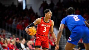 Cincinnati Bearcats guard Mika Adams-Woods handles the ball against SMU Mustangs at Fifth Third Arena. The Enquirer.