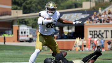WINSTON SALEM, NC - SEPTEMBER 22: Chuck Wade Jr. #9 of the Wake Forest Demon Deacons tackles Alize Mack #86 of the Notre Dame Fighting Irish during their game at BB&T Field on September 22, 2018 in Winston Salem, North Carolina. (Photo by Streeter Lecka/Getty Images)