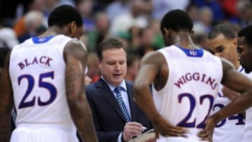 Mar 13, 2014; Kansas City, MO, USA; Kansas Jayhawks head coach Bill Self talks to forward Tarik Black (25) and guard Andrew Wiggins (22) in a timeout during the second half against the Oklahoma State Cowboys in the second round of the Big 12 Conference college basketball tournament at Sprint Center. Kansas won 77-70 in overtime. Mandatory Credit: Denny Medley-USA TODAY Sports