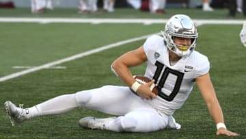 PULLMAN, WA - OCTOBER 20: PULLMAN, WA - SEPTEMBER 08: Oregon quarterback Justin Herbert (10) cradles the ball after recovering a botched snap on the Ducks first offensive play from scrimmage during the game between the Washington State Cougars and the Oregon Ducks played on October 20, 2018 in Pullman, Washington at Martin Stadium. (Photo by Robert Johnson/Icon Sportswire via Getty Images)