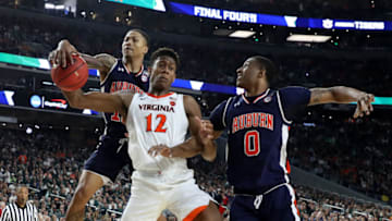 De'Andre Hunter #12 of the Virginia Cavaliers with J'Von McCormick #12 and Horace Spencer #0 of the Auburn Tigers (Photo by Streeter Lecka/Getty Images)