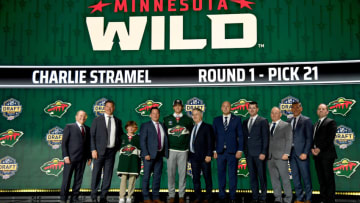 Minnesota Wild draft pick Charlie Stramel stands with Wild staff after being selected with the No. 21 pick in last week's NHL Entry Draft(Christopher Hanewinckel-USA TODAY Sports)
