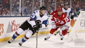 Feb 27, 2016; Denver, CO, USA; Colorado Avalanche center Nathan MacKinnon (29) carries the puck away from Detroit Red Wings right wing Tomas Jurco (26) in the first period of the Stadium Series hockey game at Coors Field. Mandatory Credit: Isaiah J. Downing-USA TODAY Sports
