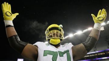 SEATTLE, WASHINGTON - NOVEMBER 06: George Moore #77 of the Oregon Ducks reacts after beating Washington Huskies 26-16 at Husky Stadium on November 06, 2021 in Seattle, Washington. (Photo by Steph Chambers/Getty Images)