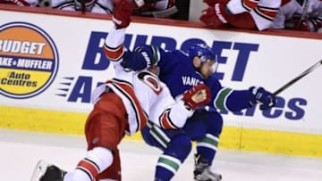 Jan 6, 2016; Vancouver, British Columbia, CAN; Carolina Hurricanes forward Joakim Nordstrom (42) goes down against Vancouver Canucks defenseman Yannick Weber (6) during the third period at Rogers Arena. The Vancouver Canucks won 3-2. Mandatory Credit: Anne-Marie Sorvin-USA TODAY Sports