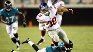 Aug 10, 2012; Jacksonville FL, USA; New York Giants defensive back Will Hill (38) breaks a tackle by Jacksonville Jaguars cornerback Antonio Dennard (16) during the fourth quarter at EverBank Field. Jacksonville defeated New York 32-31. Mandatory Credit: Douglas Jones-USA TODAY Sports
