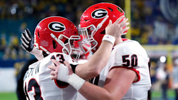 Stetson Bennett and Warren Ericson talk before the game against Michigan in the Capital One Orange Bowl for the College Football Playoff semifinal game. (Photo by Mark Brown/Getty Images)