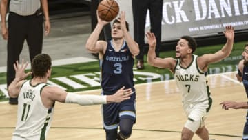 Apr 17, 2021; Milwaukee, Wisconsin, USA; Memphis Grizzlies guard Grayson Allen (3) takes a shot against Milwaukee Bucks center Brook Lopez (11) and guard Bryn Forbes (7) in the third quarter at Fiserv Forum. Mandatory Credit: Benny Sieu-USA TODAY Sports